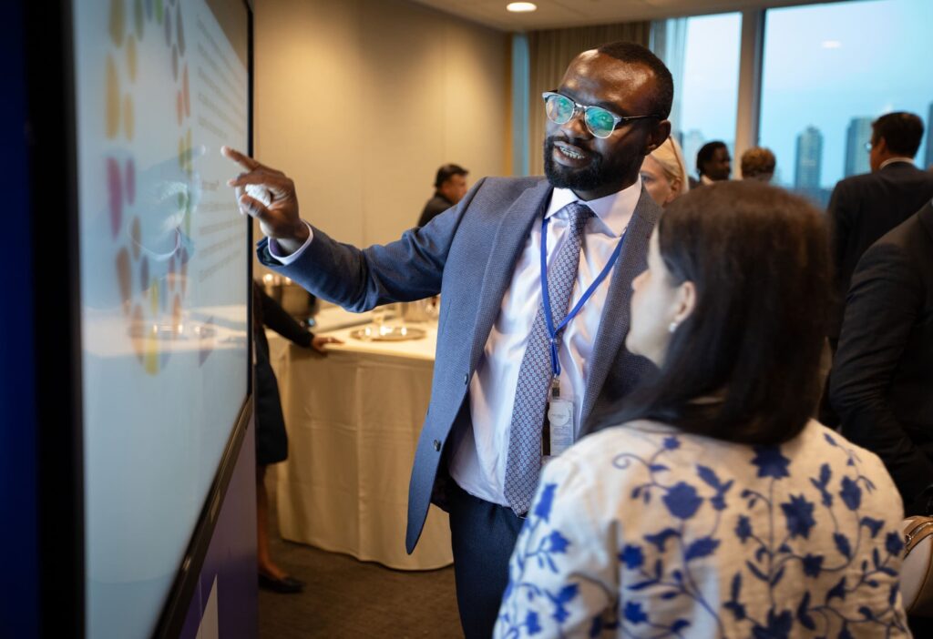 Photo from launch event showing participant interacting with touch screen